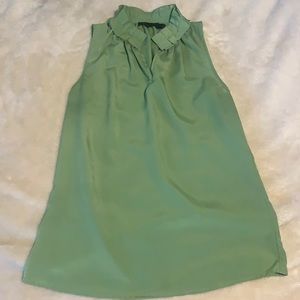 Green sleeveless top with ruffle neck